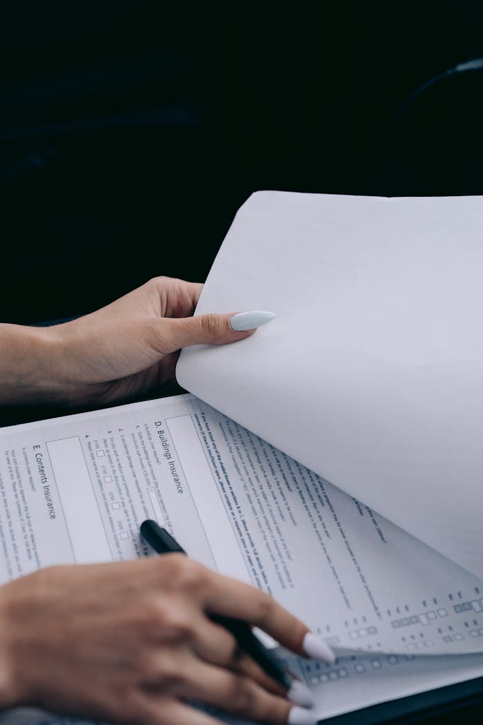 our-services-3 Detailed view of a person holding documents and a pen, ideal for business content.